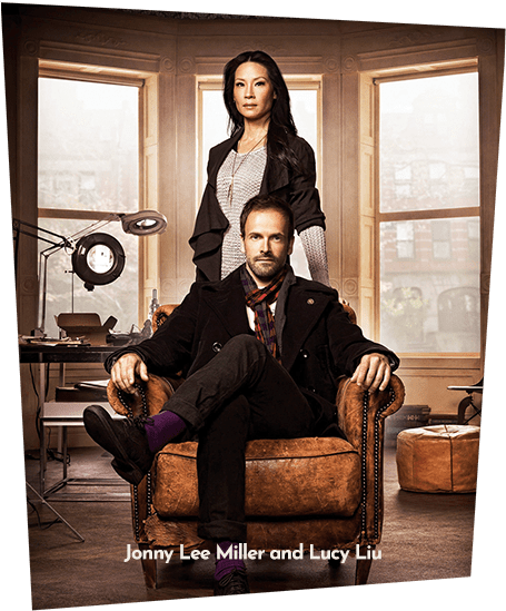 Photograph of Jonny Lee Miller and Lucy Liu as Sherlock Holmes and Watson